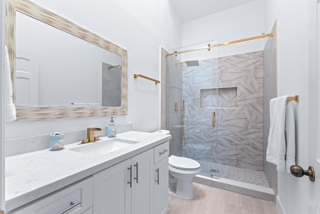 full bathroom with vanity, toilet, and a shower stall