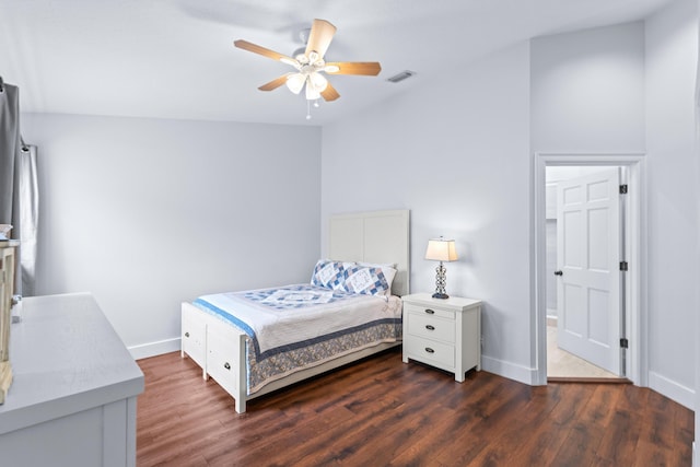 bedroom with dark wood finished floors, visible vents, a ceiling fan, and baseboards