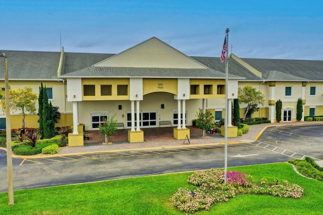 view of building exterior with uncovered parking