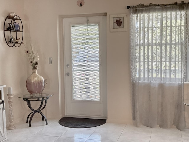 entryway with tile patterned floors and plenty of natural light