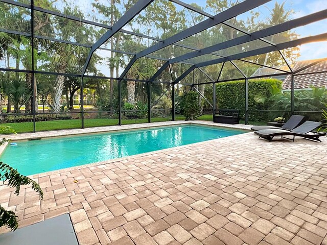 outdoor pool with a lanai and a patio