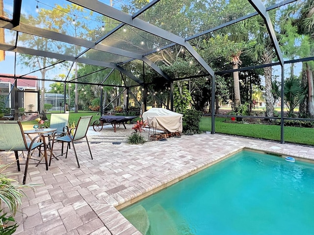 pool with glass enclosure and a patio