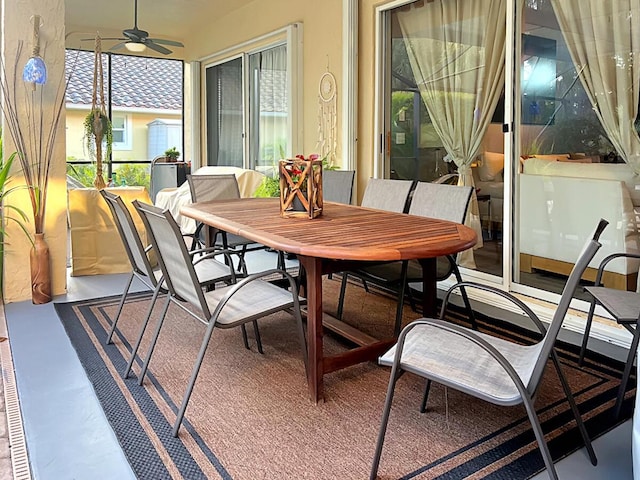 sunroom / solarium featuring a ceiling fan