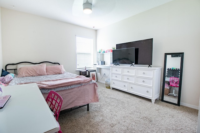 bedroom featuring a ceiling fan, light colored carpet, and baseboards