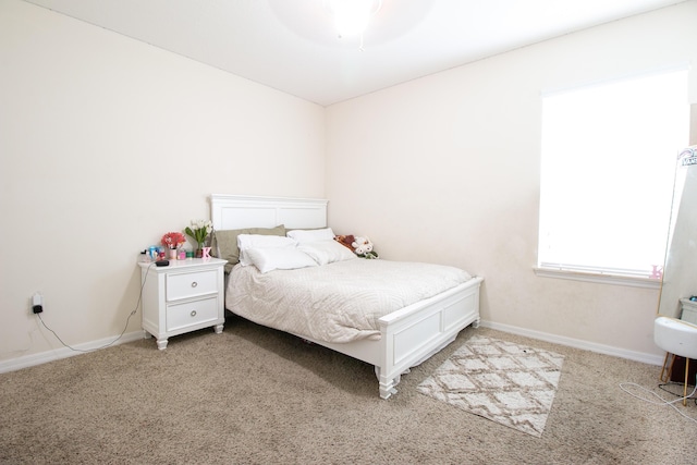 bedroom featuring ceiling fan, carpet floors, and baseboards