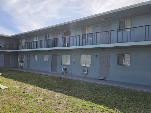 view of building exterior featuring a wall mounted air conditioner