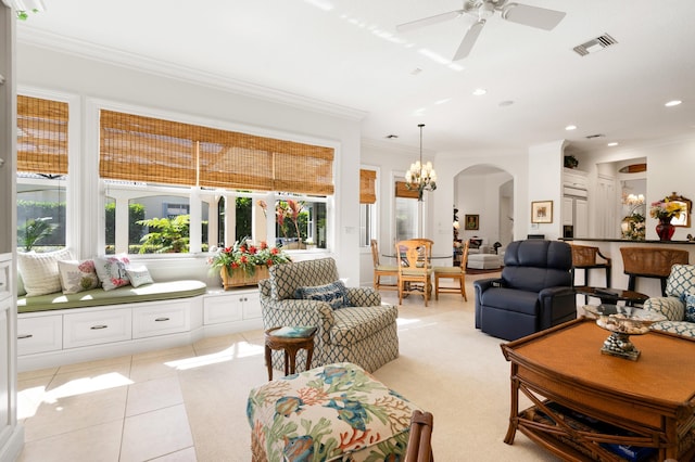 living area featuring visible vents, light tile patterned flooring, recessed lighting, arched walkways, and ornamental molding