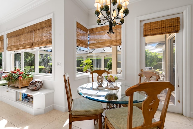 dining space with light tile patterned flooring, baseboards, an inviting chandelier, and ornamental molding