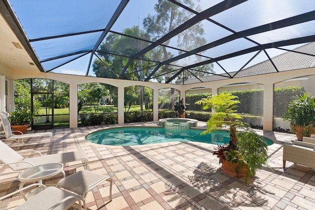 view of swimming pool with a pool with connected hot tub, a lanai, and a patio area