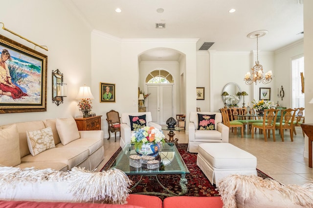 living room with tile patterned floors, a notable chandelier, arched walkways, and visible vents