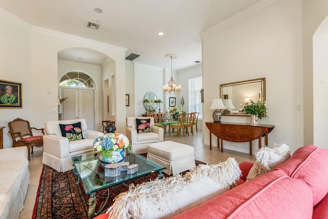 tiled living area featuring an inviting chandelier, arched walkways, visible vents, and ornamental molding