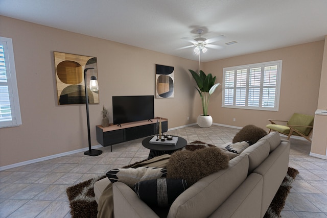 living area featuring visible vents, ceiling fan, and baseboards