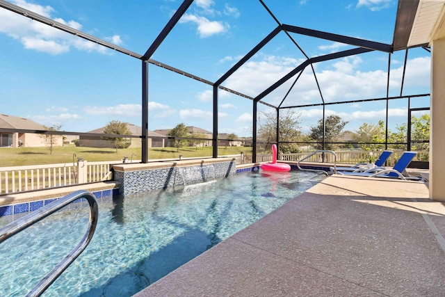 outdoor pool featuring a lawn, a lanai, and a patio area