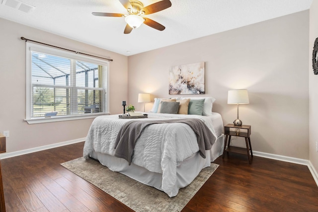 bedroom with visible vents, a ceiling fan, baseboards, and hardwood / wood-style floors