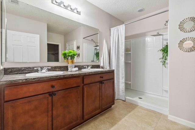 full bath featuring a textured ceiling, a shower with shower curtain, and a sink