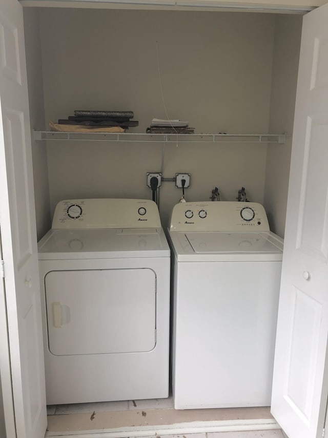 clothes washing area featuring laundry area and separate washer and dryer