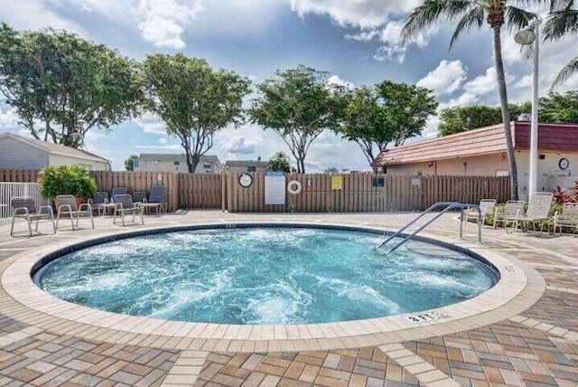 view of pool featuring fence and a patio