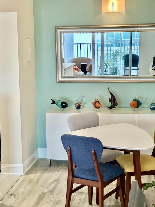 dining area featuring wood finished floors and baseboards