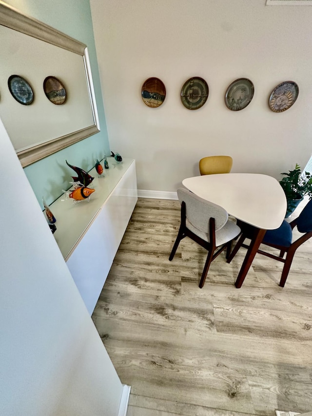 bathroom with baseboards and wood finished floors