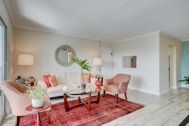 living area featuring crown molding, wood finished floors, and baseboards