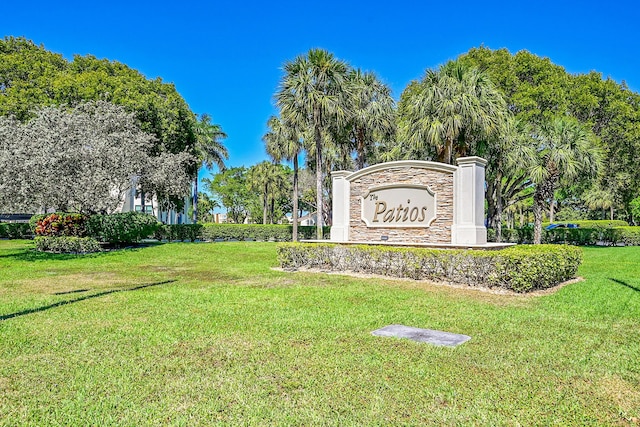 community sign featuring a lawn