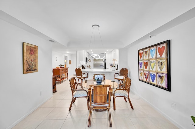 dining area with light tile patterned floors, visible vents, and baseboards