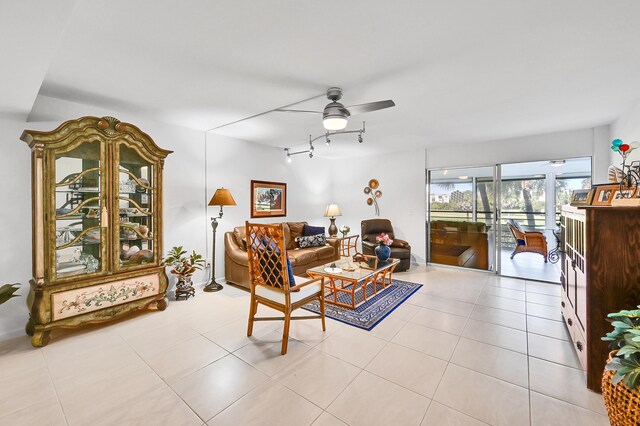 tiled living room featuring rail lighting and a ceiling fan