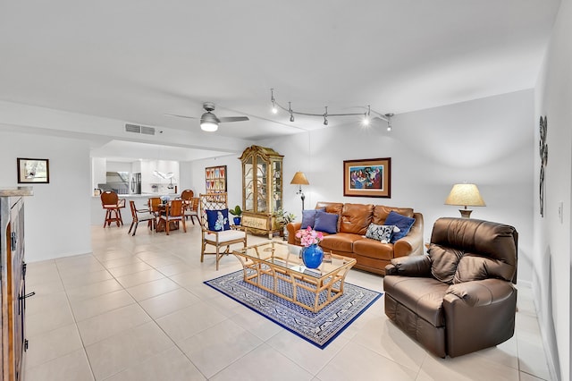 living room with rail lighting, visible vents, light tile patterned flooring, and a ceiling fan