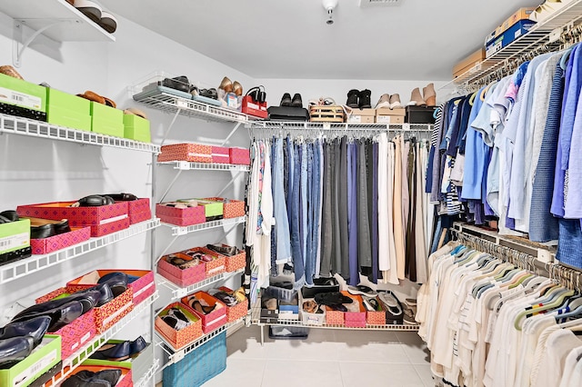 walk in closet with tile patterned floors