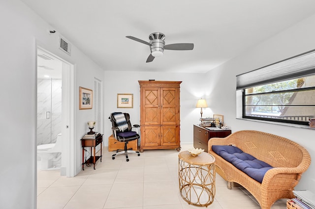 sitting room featuring light tile patterned floors, visible vents, and ceiling fan