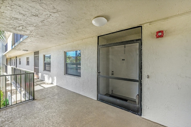 view of exterior entry with stucco siding