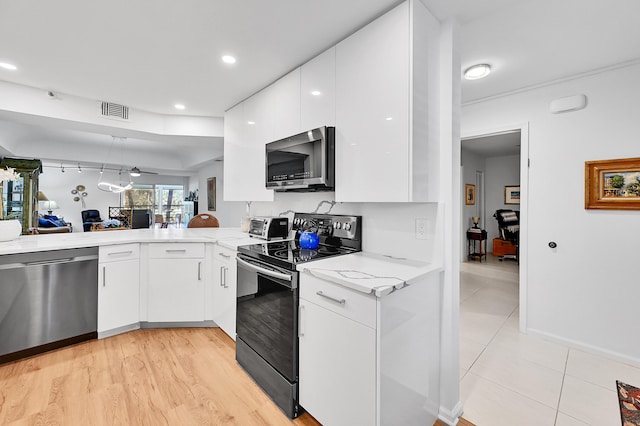 kitchen featuring light stone countertops, visible vents, appliances with stainless steel finishes, white cabinetry, and modern cabinets