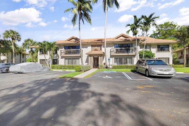 view of property featuring uncovered parking