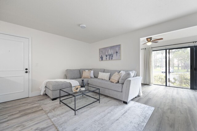 living area with wood finished floors and baseboards