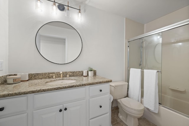 full bath with tile patterned flooring, enclosed tub / shower combo, vanity, and toilet