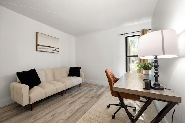 office space with light wood finished floors and baseboards