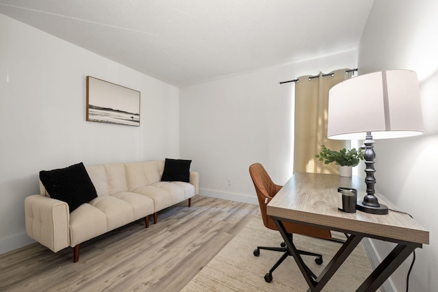 office area featuring light wood finished floors and baseboards