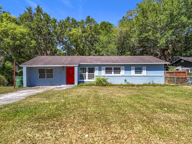 1201 Susan St, Leesburg, FL 34748 - ranch-style house with a front yard, fence, and brick siding
