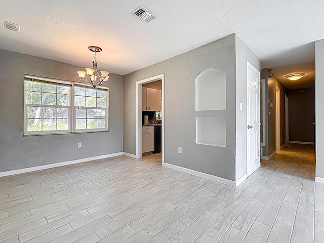 1201 Susan St, Leesburg, FL 34748 - unfurnished room featuring a chandelier, light wood finished floors, baseboards, and visible vents
