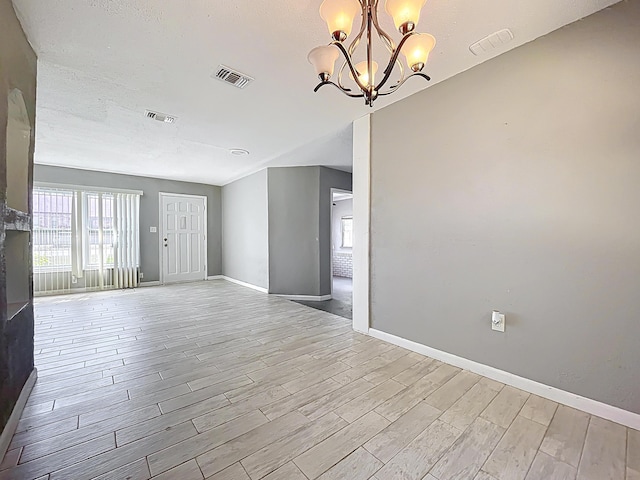 1201 Susan St, Leesburg, FL 34748 - unfurnished room featuring an inviting chandelier, light wood-style floors, baseboards, and visible vents