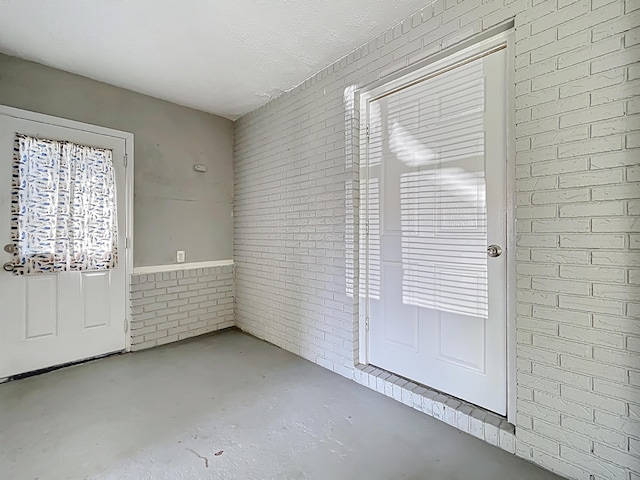 1201 Susan St, Leesburg, FL 34748 - interior space featuring brick wall and unfinished concrete flooring