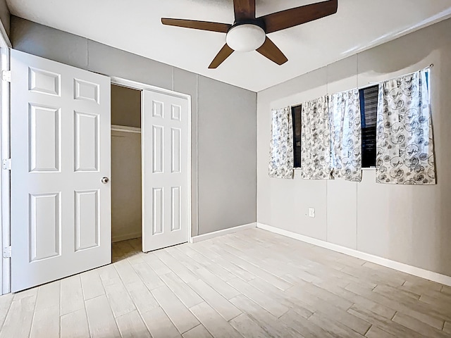 1201 Susan St, Leesburg, FL 34748 - unfurnished bedroom with a closet, baseboards, ceiling fan, and light wood-style floors