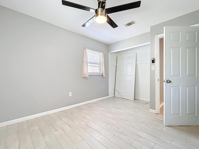 1201 Susan St, Leesburg, FL 34748 - unfurnished bedroom with baseboards, a closet, light wood-style floors, visible vents, and ceiling fan