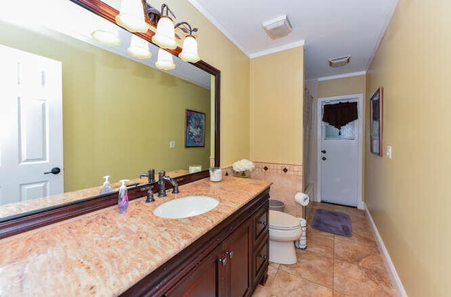bathroom with tile patterned flooring, toilet, vanity, ornamental molding, and baseboards
