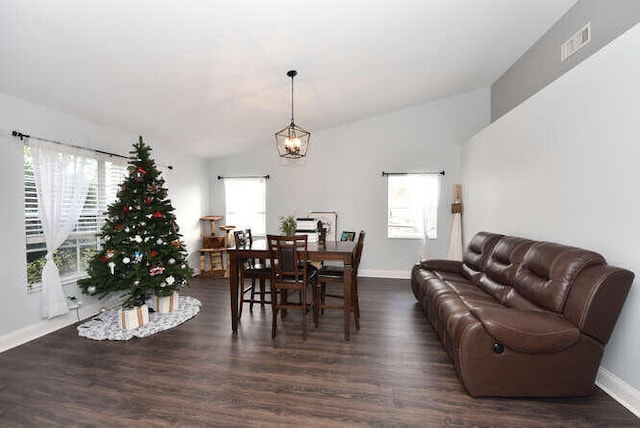 dining space featuring baseboards, visible vents, a chandelier, and dark wood-style flooring