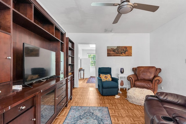 living room featuring visible vents and ceiling fan