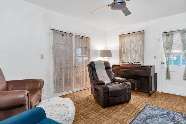 sitting room with a ceiling fan