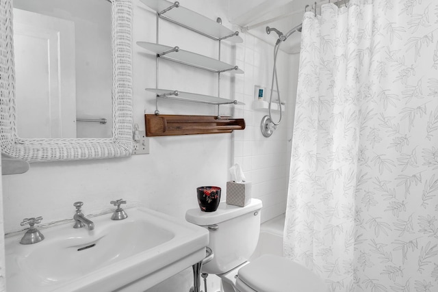 full bath with a sink, toilet, and shower / tub combo