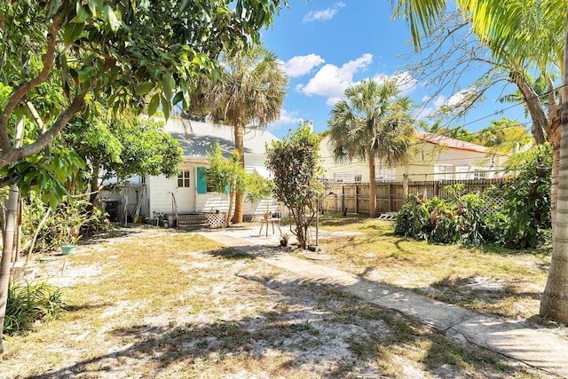 view of yard with entry steps and fence