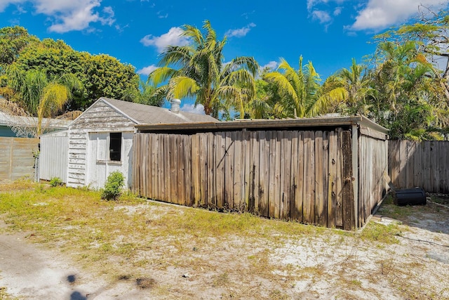 view of outbuilding featuring an outbuilding and fence